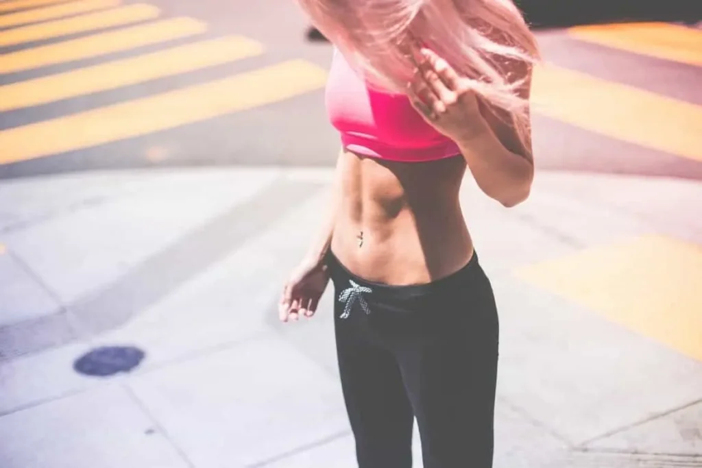 Woman with toned stomach after LA-EMS Body Sculpting Treatment Ponders End